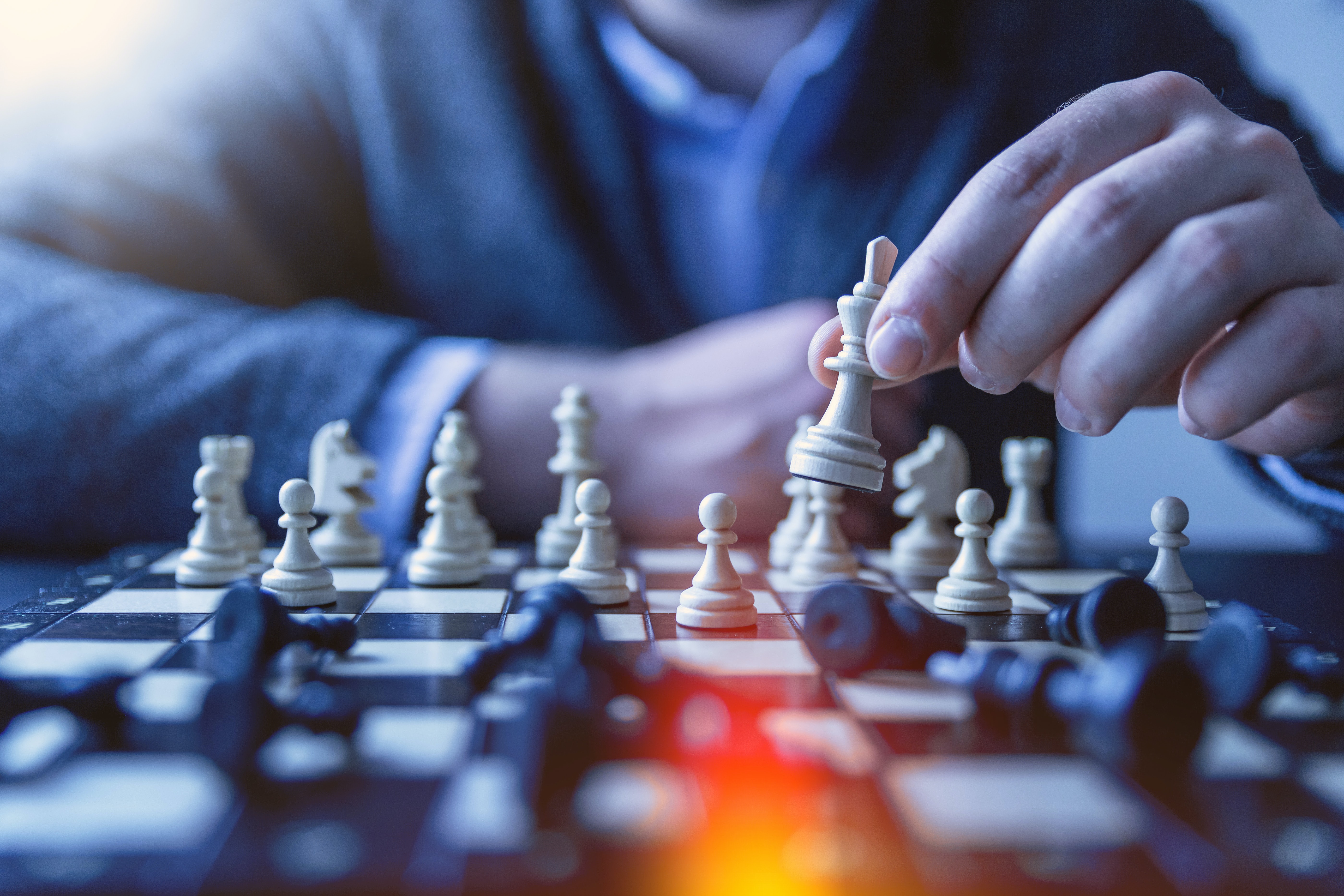 Photo of a chess board with many fallen pieces